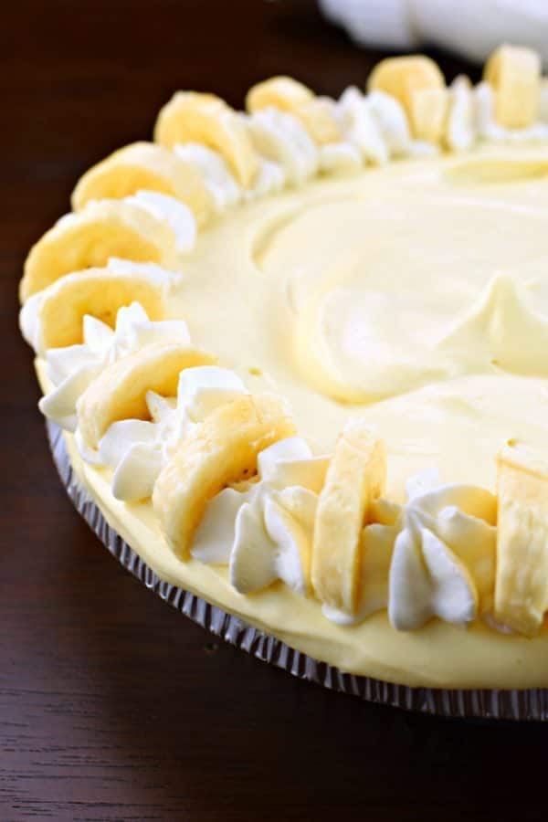 This Dulce de Leche Banana Cream Pie recipe has it all! Graham Cracker crust topped with dulce de leche and bananas with a no bake banana cheesecake filling!