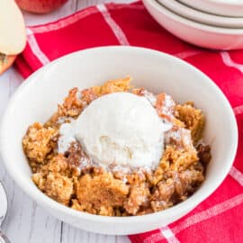 This Slow Cooker Apple Cake is as easy as tossing a few ingredients into your crockpot and letting it do it's thing! Serve it warm with a big scoop of ice cream on top!