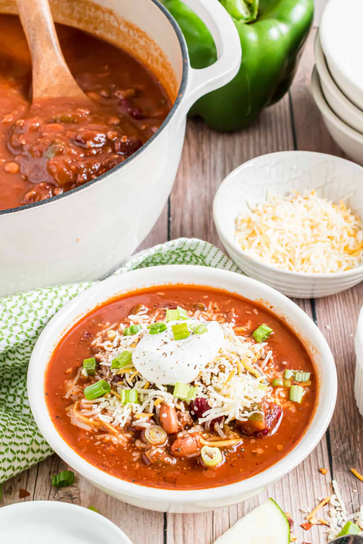 Bowl of chili with cheese and sour cream.