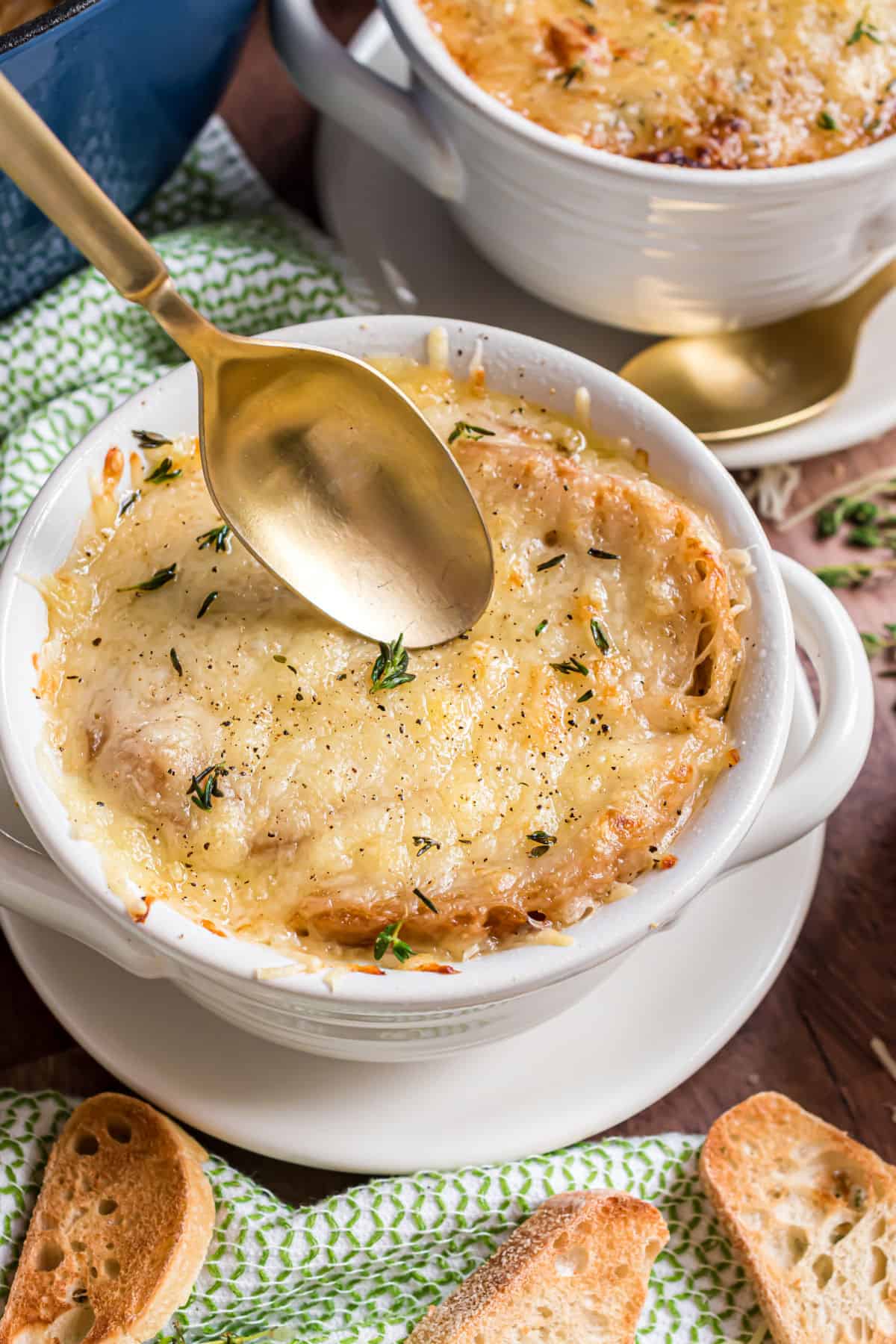 Bowl of french onion soup topped with melted cheese.