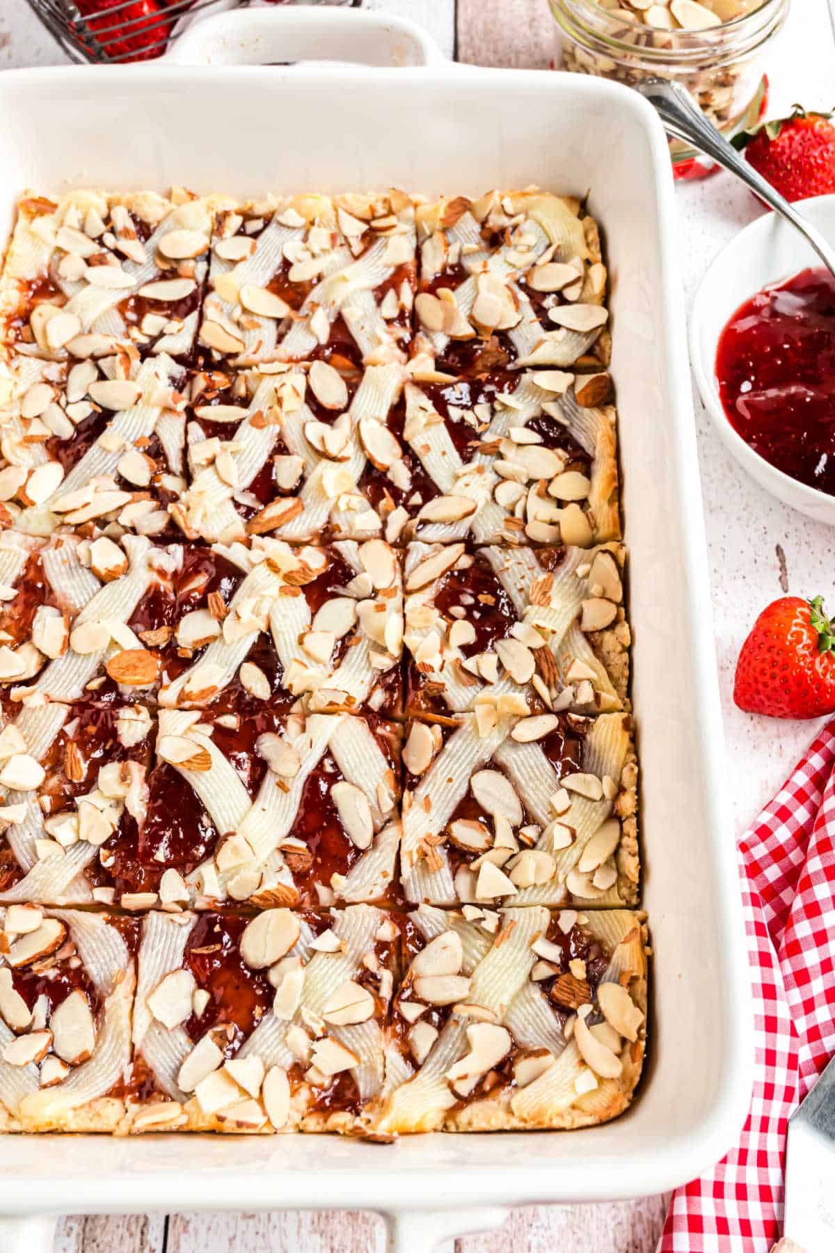 Strawberry almond bars baked in a white 13x9 baking dish.