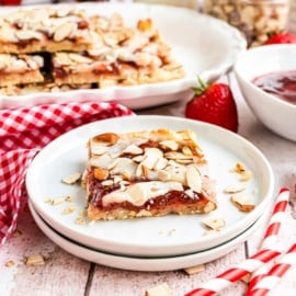 These Strawberry Almond Bars have a crunchy almond crust, chewy strawberry filling, and a creamy cheesecake topping. Perfect for holidays or weekend brunches!