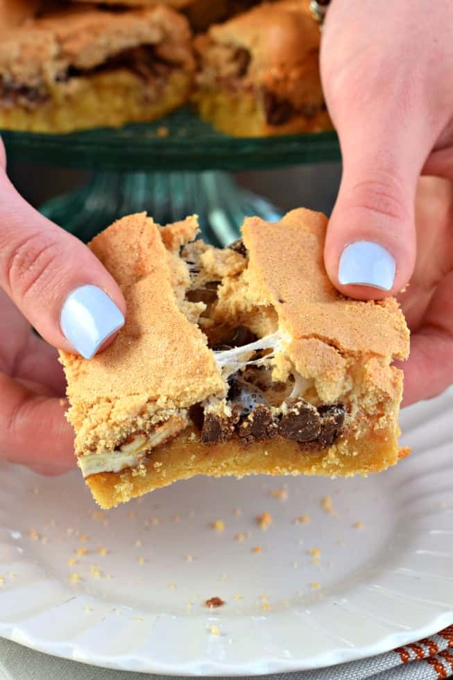 Mud hen bar being broken in half, revealing a gooey marshmallow bar.