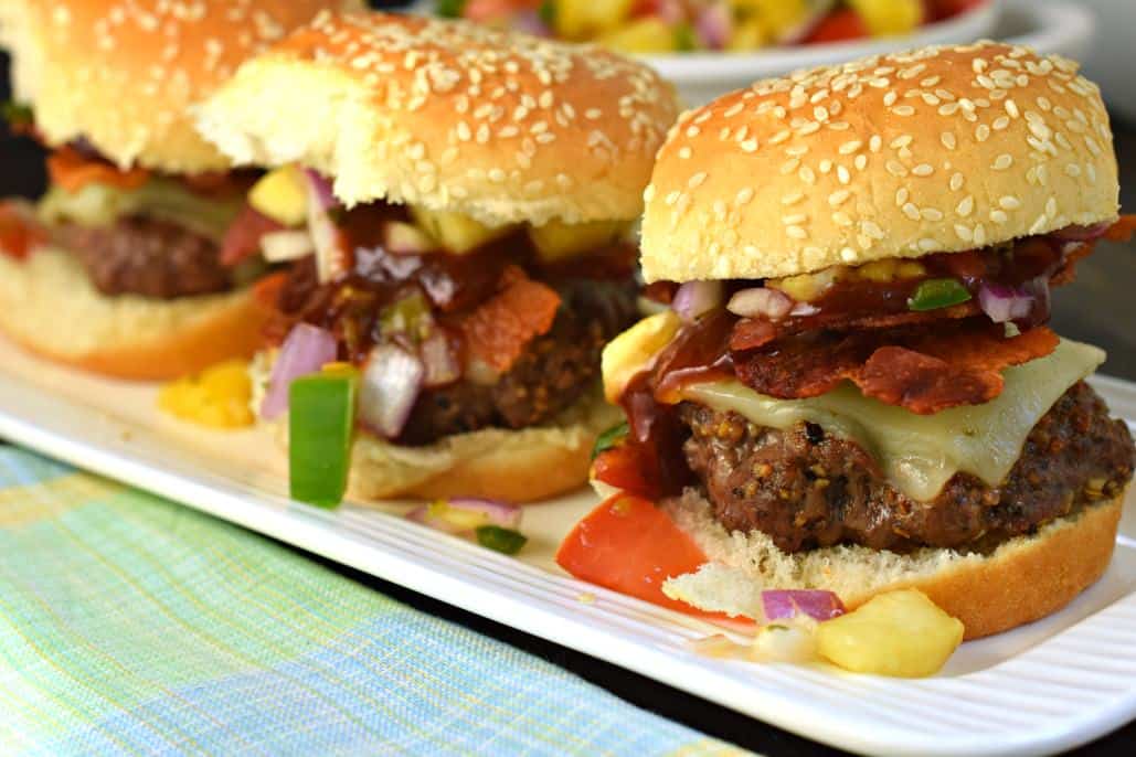 Hawaiian Sliders topped with cheese, bacon, salsa, and bbq sauce.