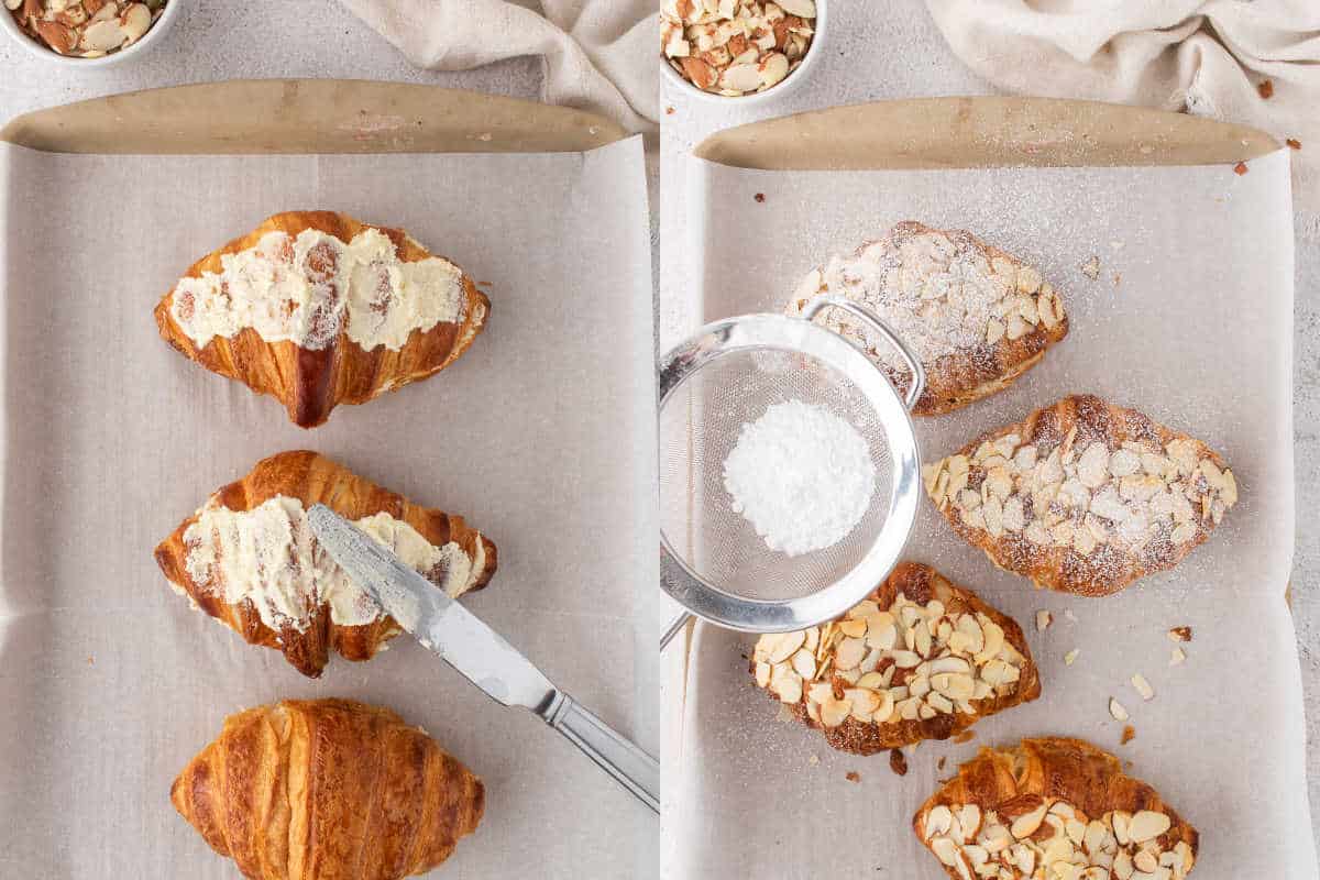 Three easy almond croissants being filled, topped with almonds, and dusted with powdered sugar on a parchment-lined tray.