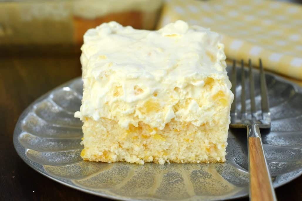 Pineapple Orange Cake is an easy, light dessert recipe that's nearly guilt free! You'll love the refreshing, moist orange cake topped with creamy pineapple flavored frosting!