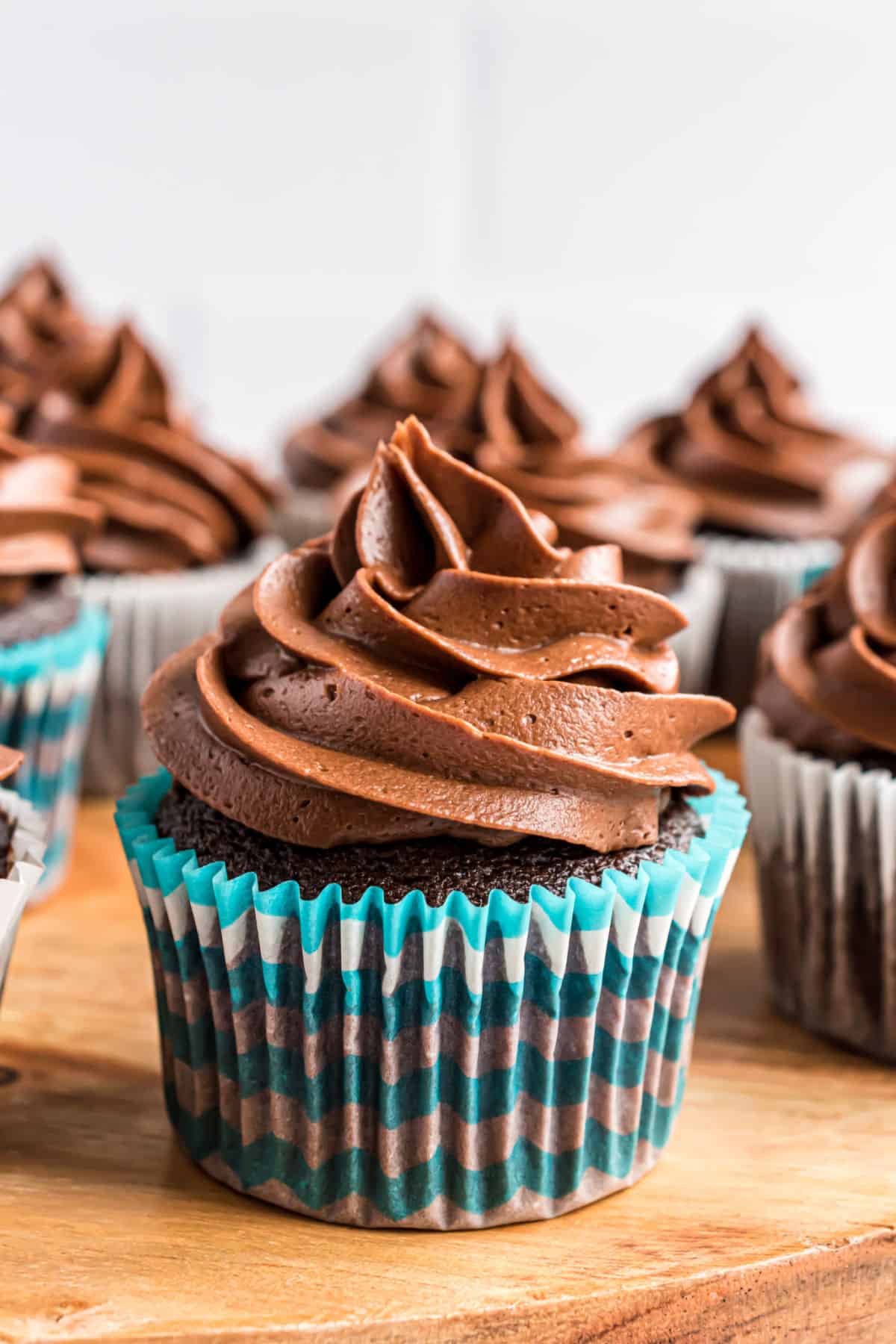 Chocolate cupcakes topped with swirls of chocolate frosting.