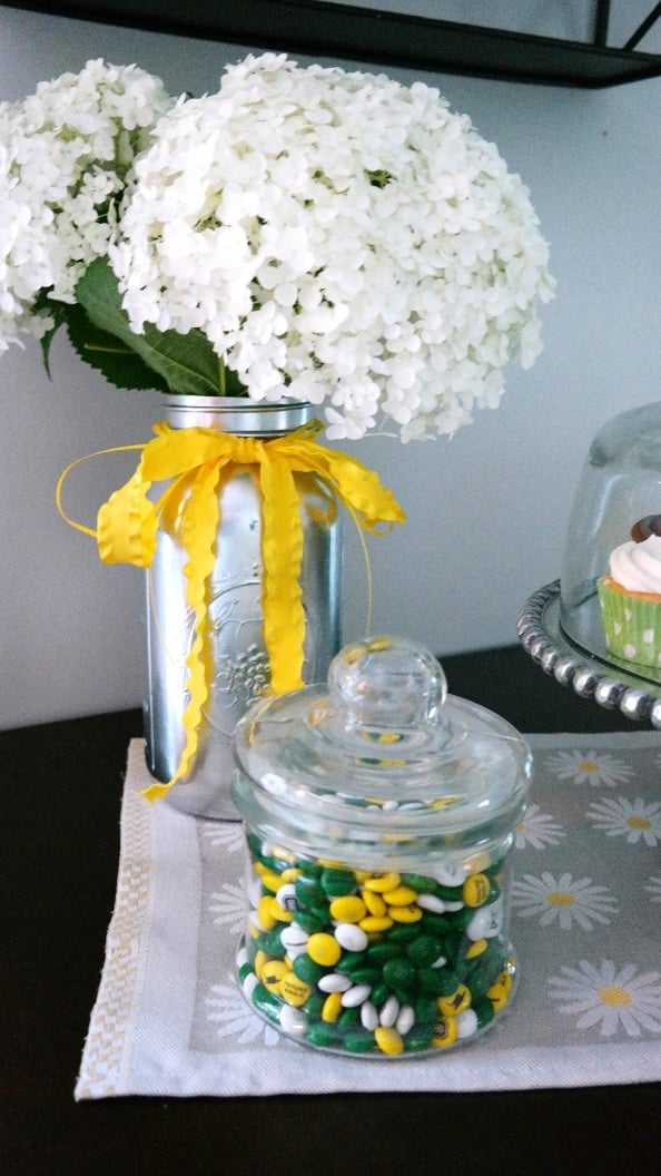 Spray Paint mason jars silver and add flowers from your garden for centerpieces!