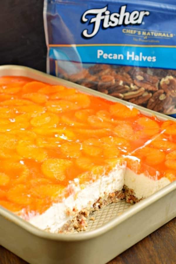 Sweet and salty, this Mandarin Orange Pretzel Bars recipe is the perfect dish to share this summer! You'll love the nutty pecans in the crust of this sweet treat!