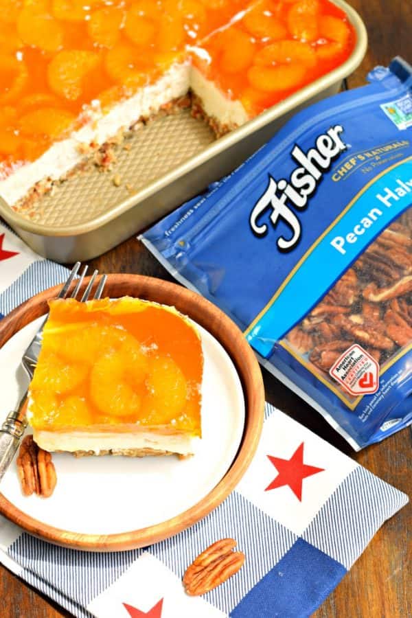 Sweet and salty, this Mandarin Orange Pretzel Bars recipe is the perfect dish to share this summer! You'll love the nutty pecans in the crust of this sweet treat!