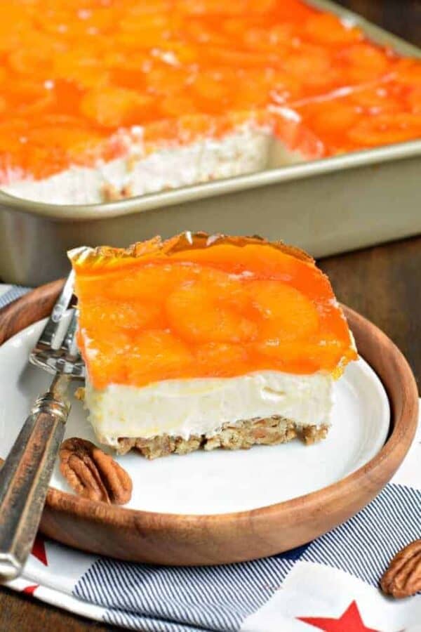 Sweet and salty, this Mandarin Orange Pretzel Bars recipe is the perfect dish to share this summer! You'll love the nutty pecans in the crust of this sweet treat!