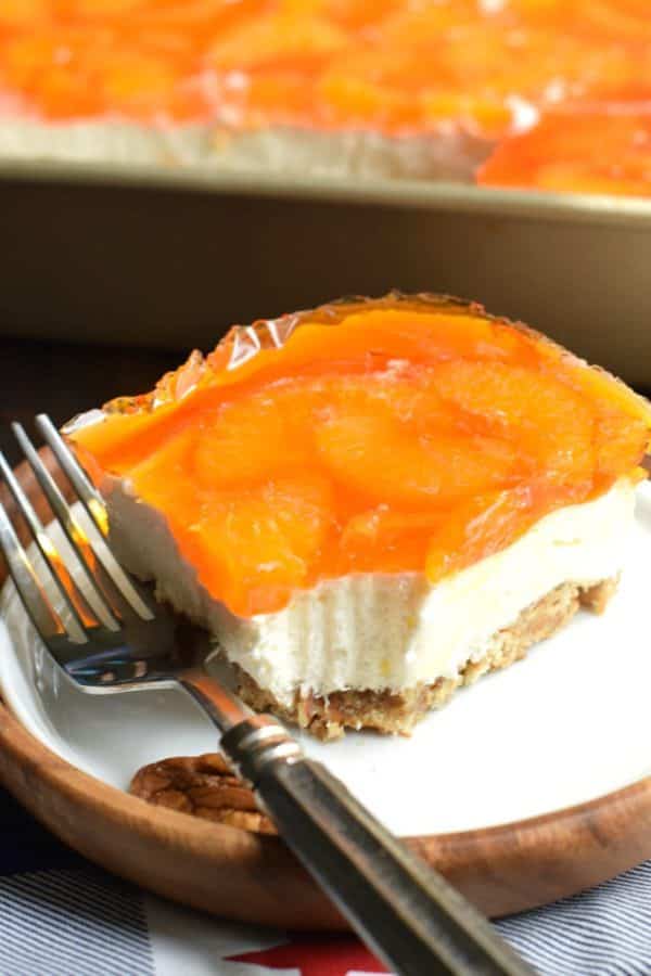 Sweet and salty, this Mandarin Orange Pretzel Bars recipe is the perfect dish to share this summer! You'll love the nutty pecans in the crust of this sweet treat!