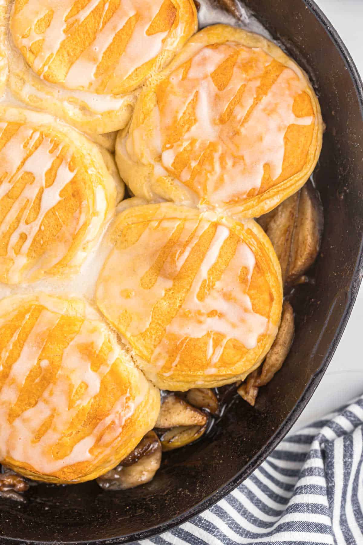Cast iron skillet willed with apples and biscuits.