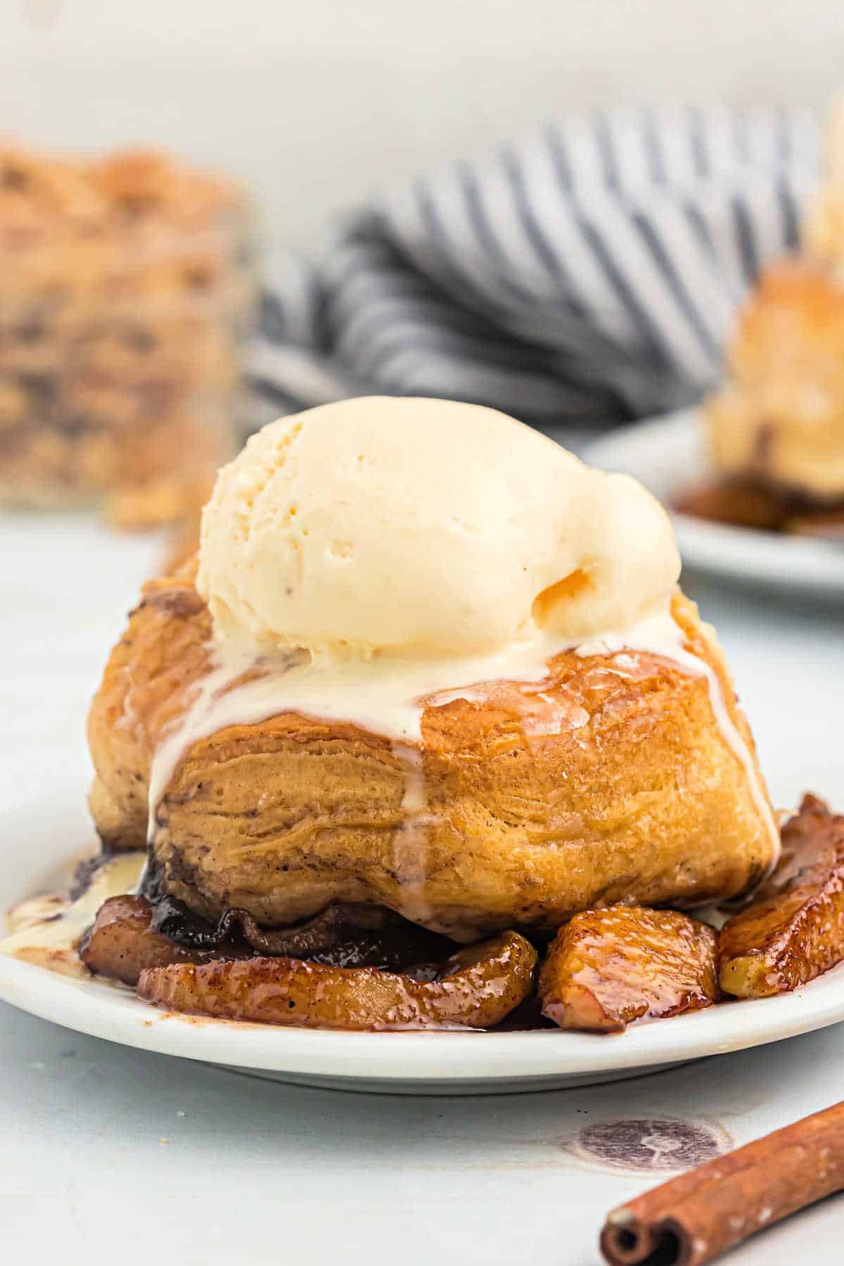 Scoop of apples and biscuit topped with vanilla ice cream.