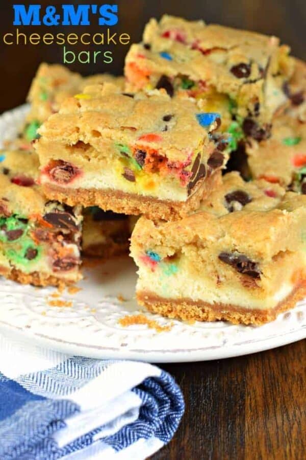 These M&M Cheesecake Bars have a sweet graham cracker crust, creamy cheesecake filling, and a chocolate chip cookie dough packed with M&M's on top!