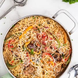 Large skillet with cajun sausage pasta.