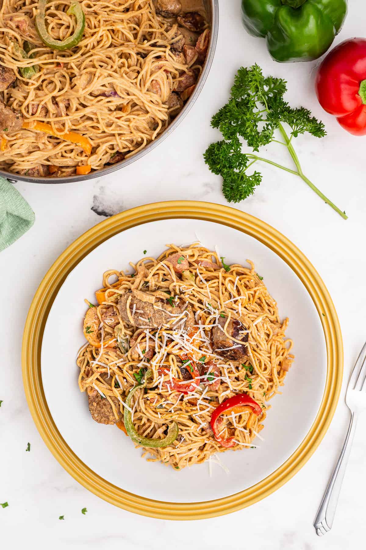 Large plate with cajun sausage pasta served.