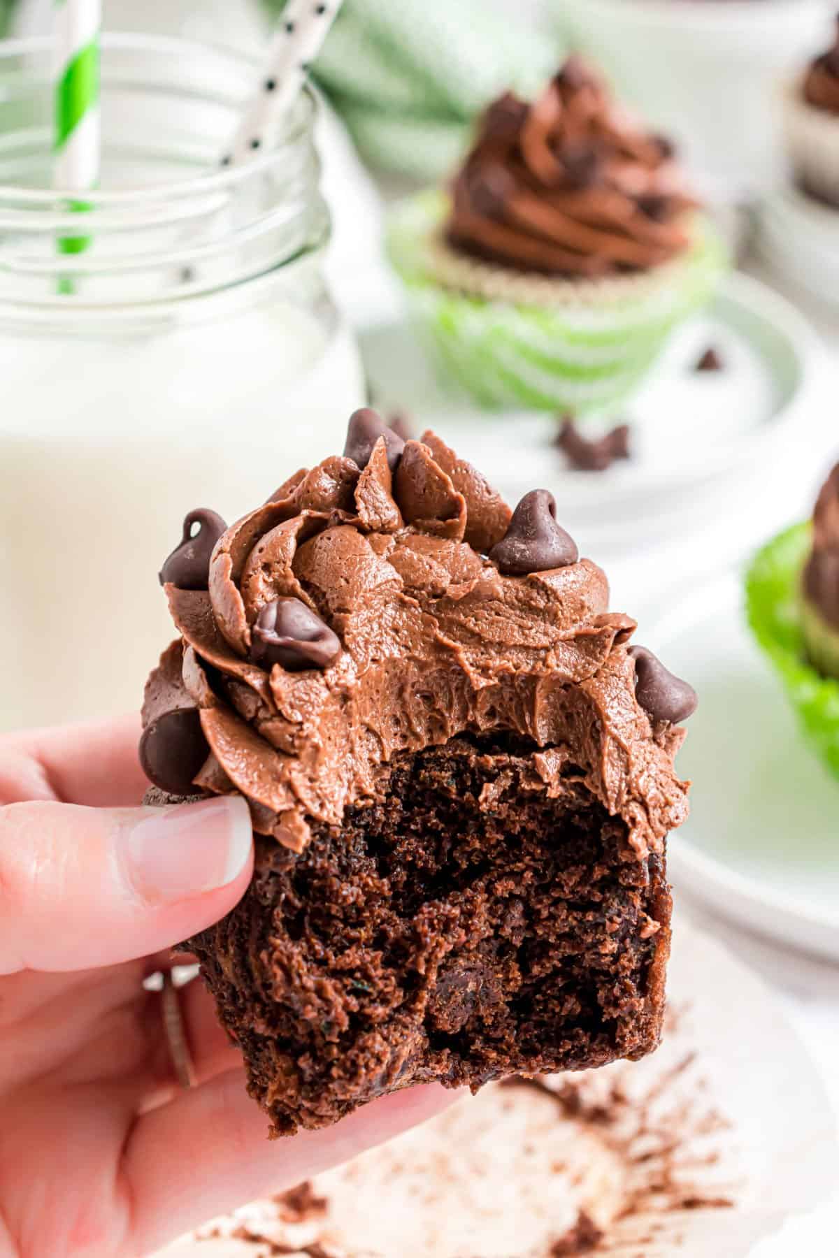 Chocolate frosted cupcake with a bite taken out.