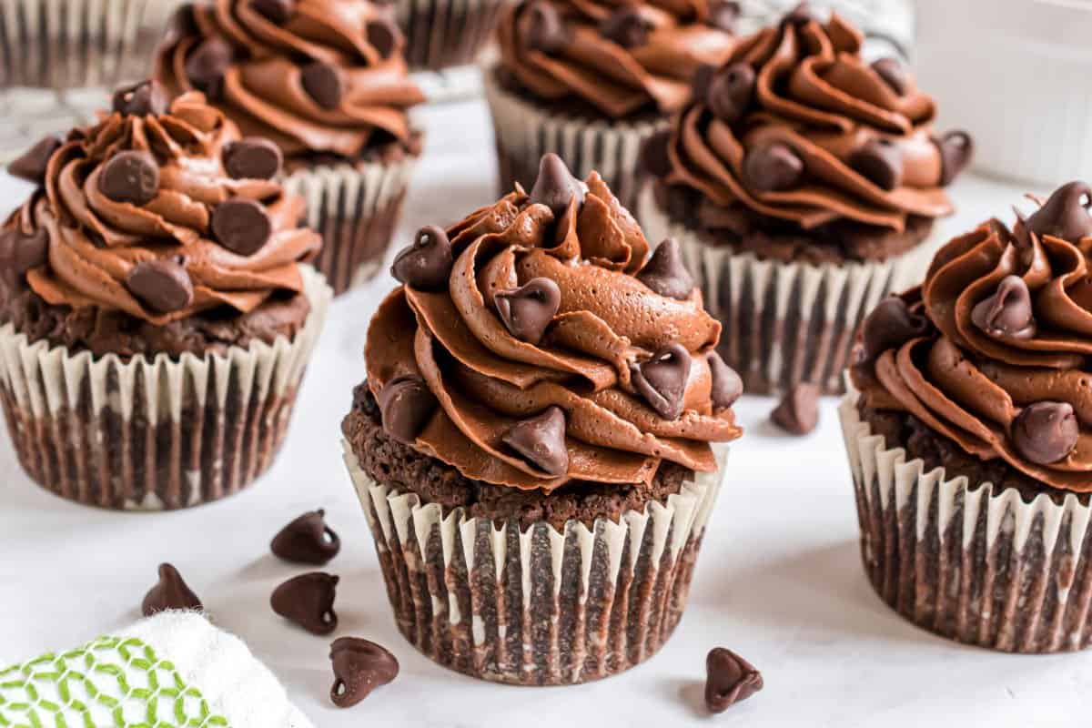 Chocolate Chip Zucchini Cupcakes are so moist and fudgy, you'd never guess there's a vegetable hiding inside! Easy to make with easy ingredients and a rich chocolate frosting, this zucchini cupcake recipe is an instant hit.