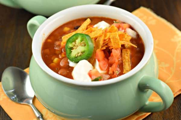 Thick and hearty, this Slow Cooker Vegetarian Lentil Tortilla Soup recipe is the perfect weeknight meal! You'll love the spicy flavor and you won't miss the meat!