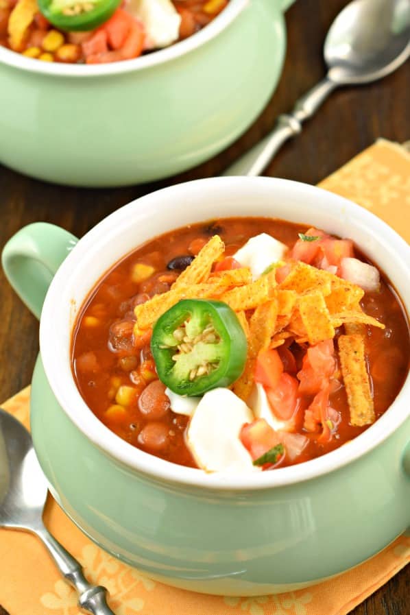Thick and hearty, this Slow Cooker Vegetarian Lentil Tortilla Soup recipe is the perfect weeknight meal! You'll love the spicy flavor and you won't miss the meat!