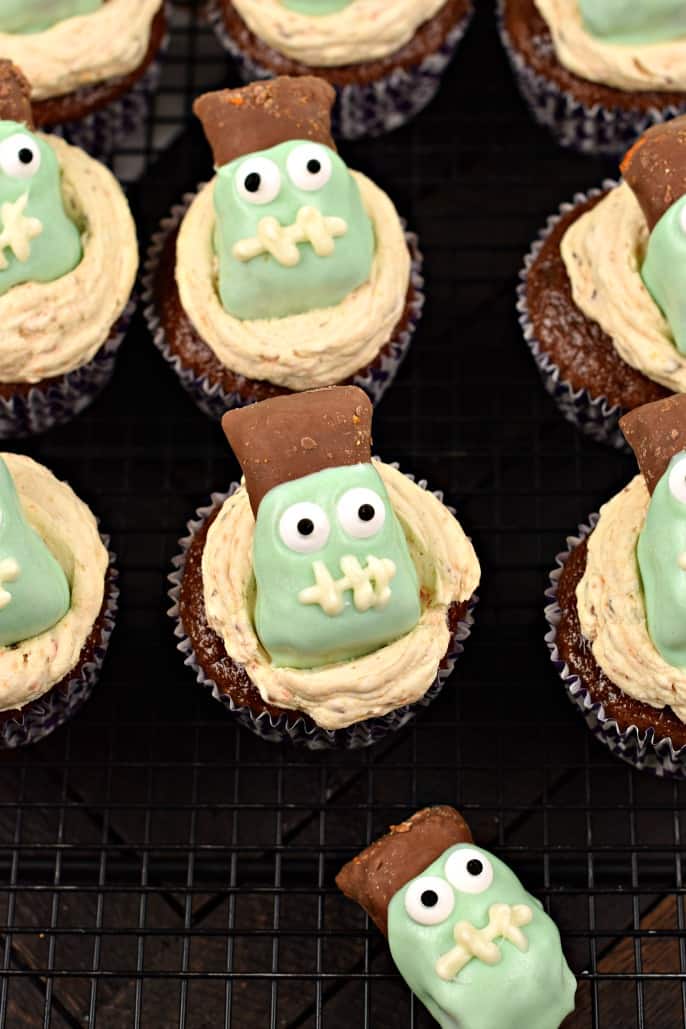 Butterfinger cupcakes on a wire rack with frankenstein decorations.