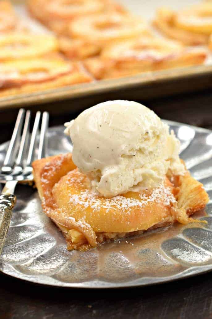 Slice of apple tart with vanilla bean ice cream.