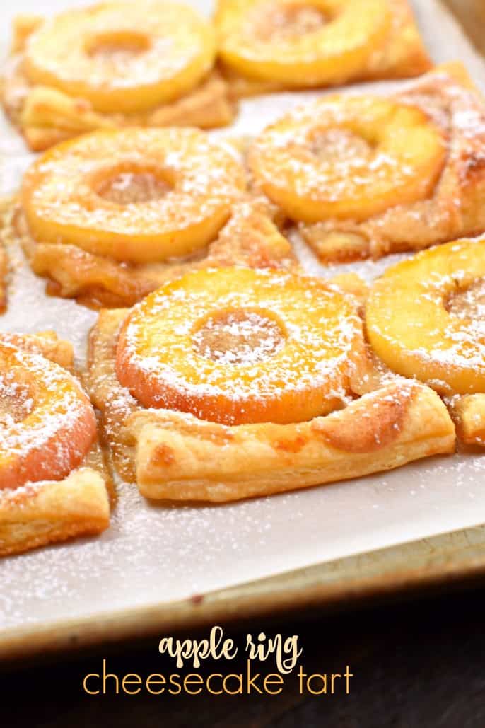 Apple tart with dough, apple rings, and powdered sugar.