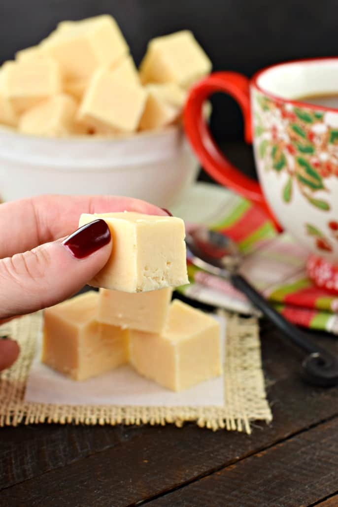 Piece of butter rum fudge being held for close up.