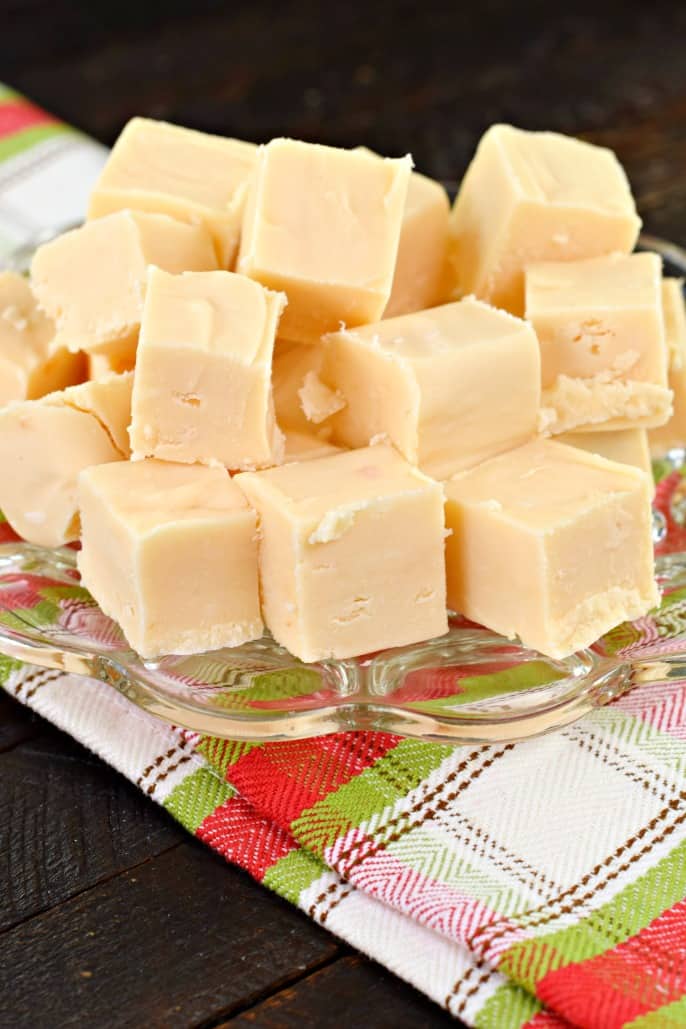 Pieces of butter rum fudge on clear glass plate.