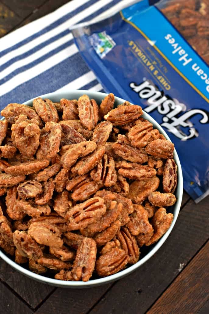 Fisher nuts pecan halves baked with a brown sugar maple coating and served in a light blue bowl.