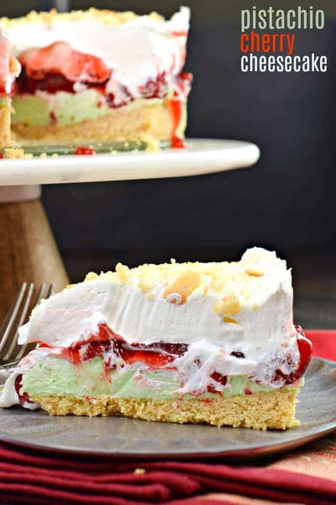 Slice of cheesecake with pistachio pudding, cherries, and whipped cream.