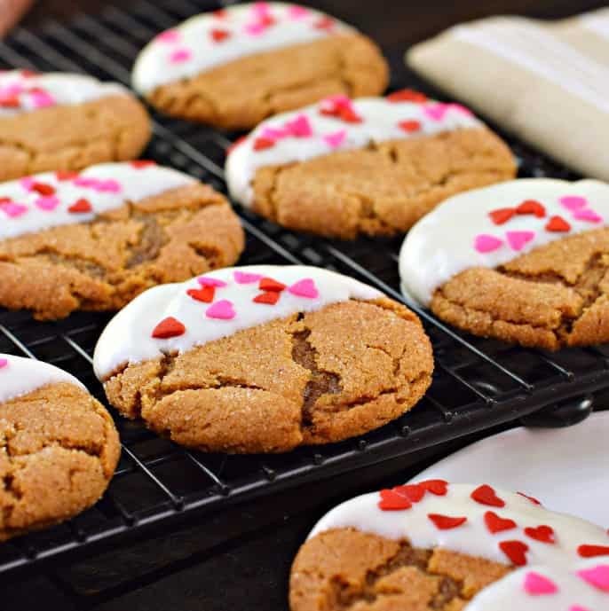 Chewy gingerdoodle cookies dipped in white chocolate with valentine's day sprinkles.