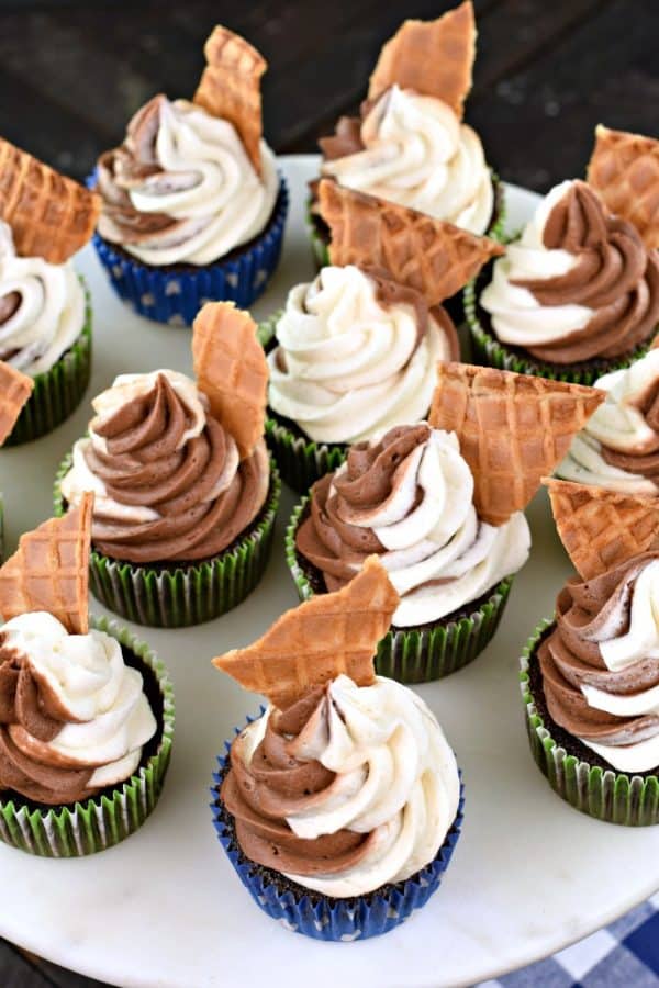 Plate of cupcakes, CHOCOLATE VANILLA SWIRLED FROSTING on a CHOCOLATE CUPCAKE in a blue wrapper with a WAFFLE CONE, CHOCOLATE, BUTTERCREAM FROSTING, FROM SCRATCH