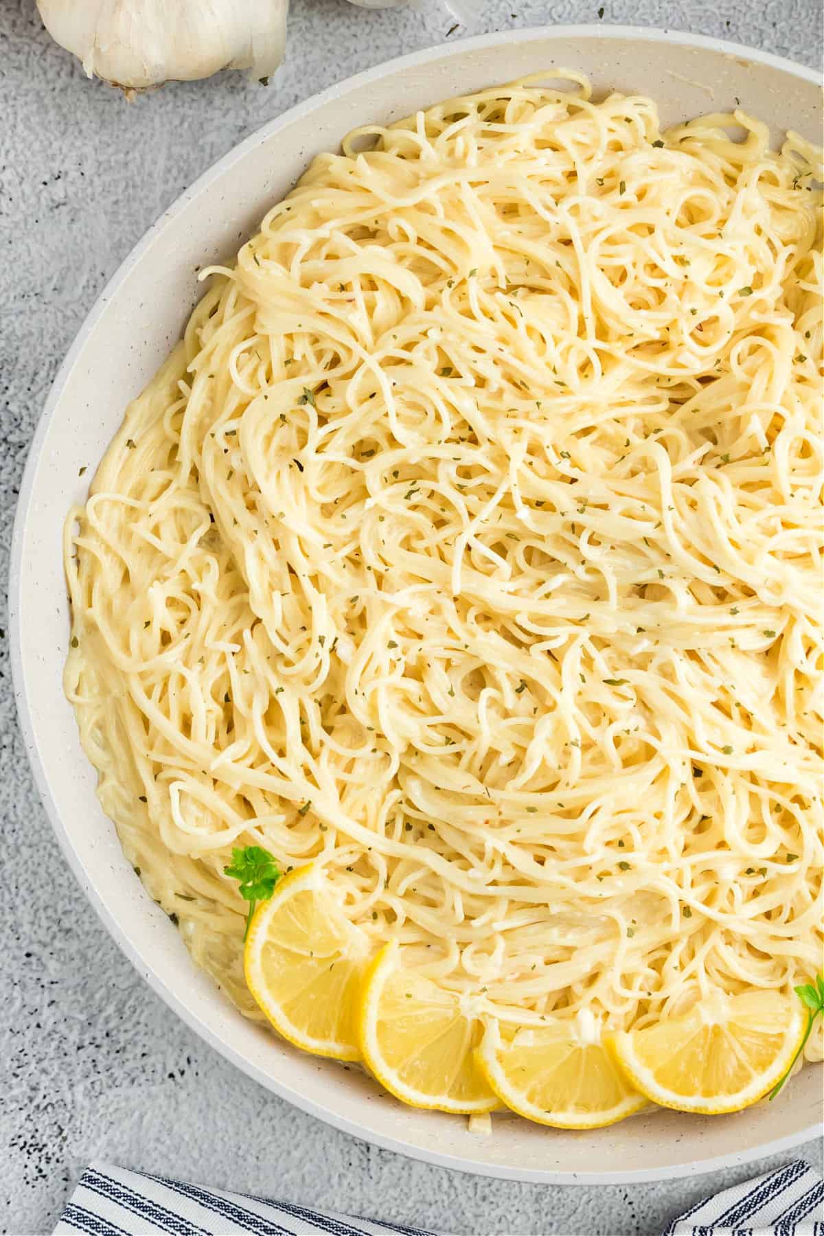 Pasta in a lemon garlic alfredo sauce served in a white bowl.