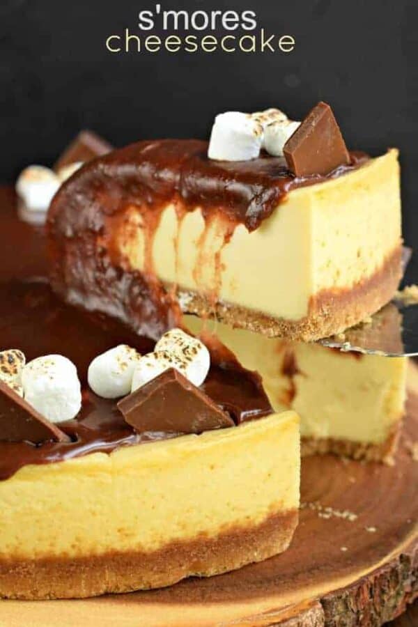 Mouthwatering and perfect, this S'mores Cheesecake recipe is made with marshmallow cream and homemade chocolate ganache. Make the cheesecake ahead of time and top it when you're ready to enjoy! #cheesecake #smores S'mores Cheesecake slice