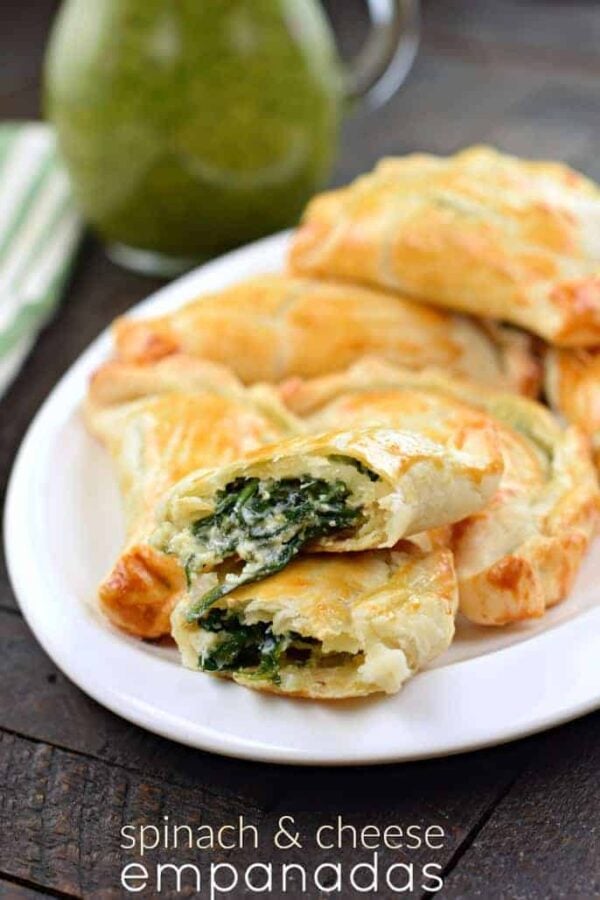 Flaky pie crust filled with fresh spinach, garlic, and ricotta cheese. These Spinach and Cheese Empanadas are an easy dinner or appetizer recipe, and best served with fresh Chimichurri sauce! Spinach and Cheese Empanadas on plate