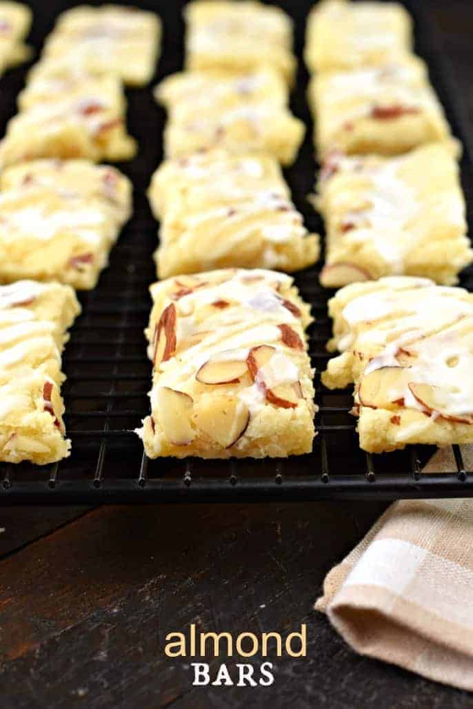 Almond Bars cut into rectangles and cooling on a black wire rack.