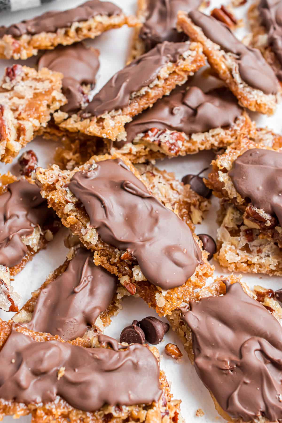 Graham cracker toffee stacked on parchment paper.