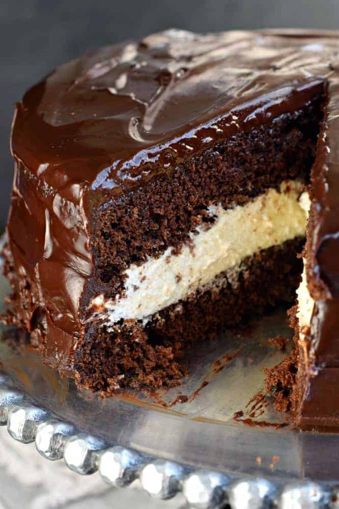 Ding Dong Cake with one slice removed on a silver cake plate.