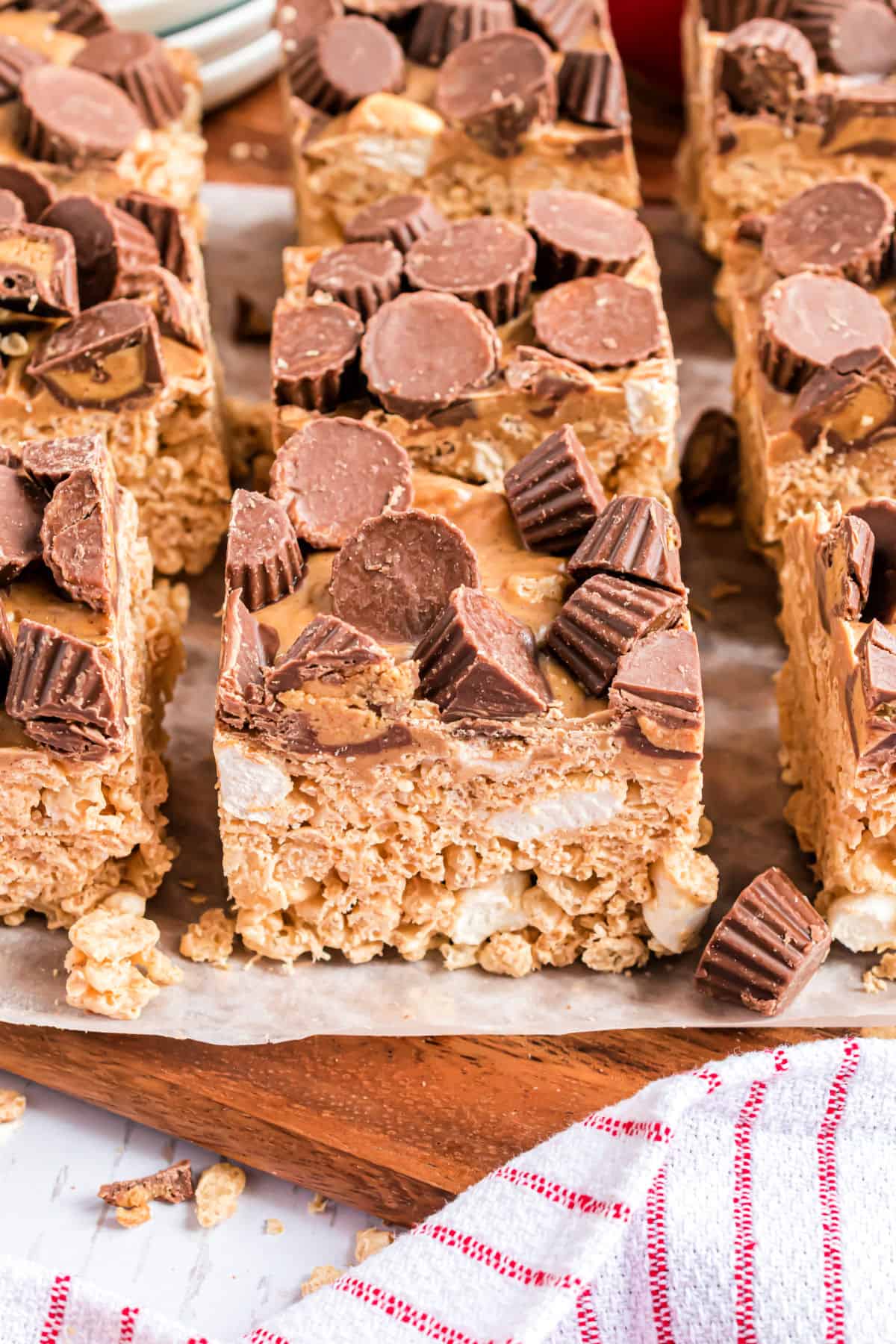 Peanut butter rice krispie treats topped with reese's peanut butter cups.