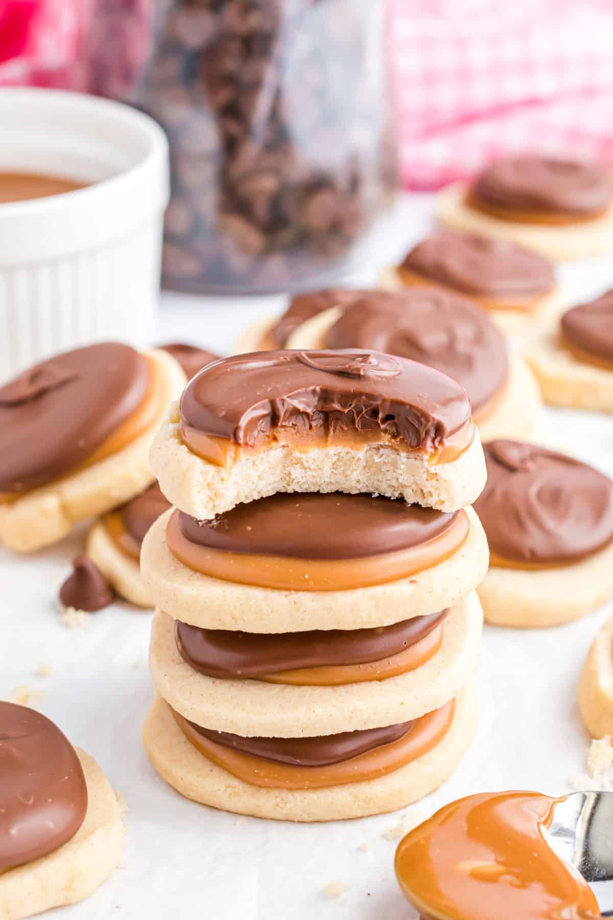 Stack of four twix cookies on parchment paper.