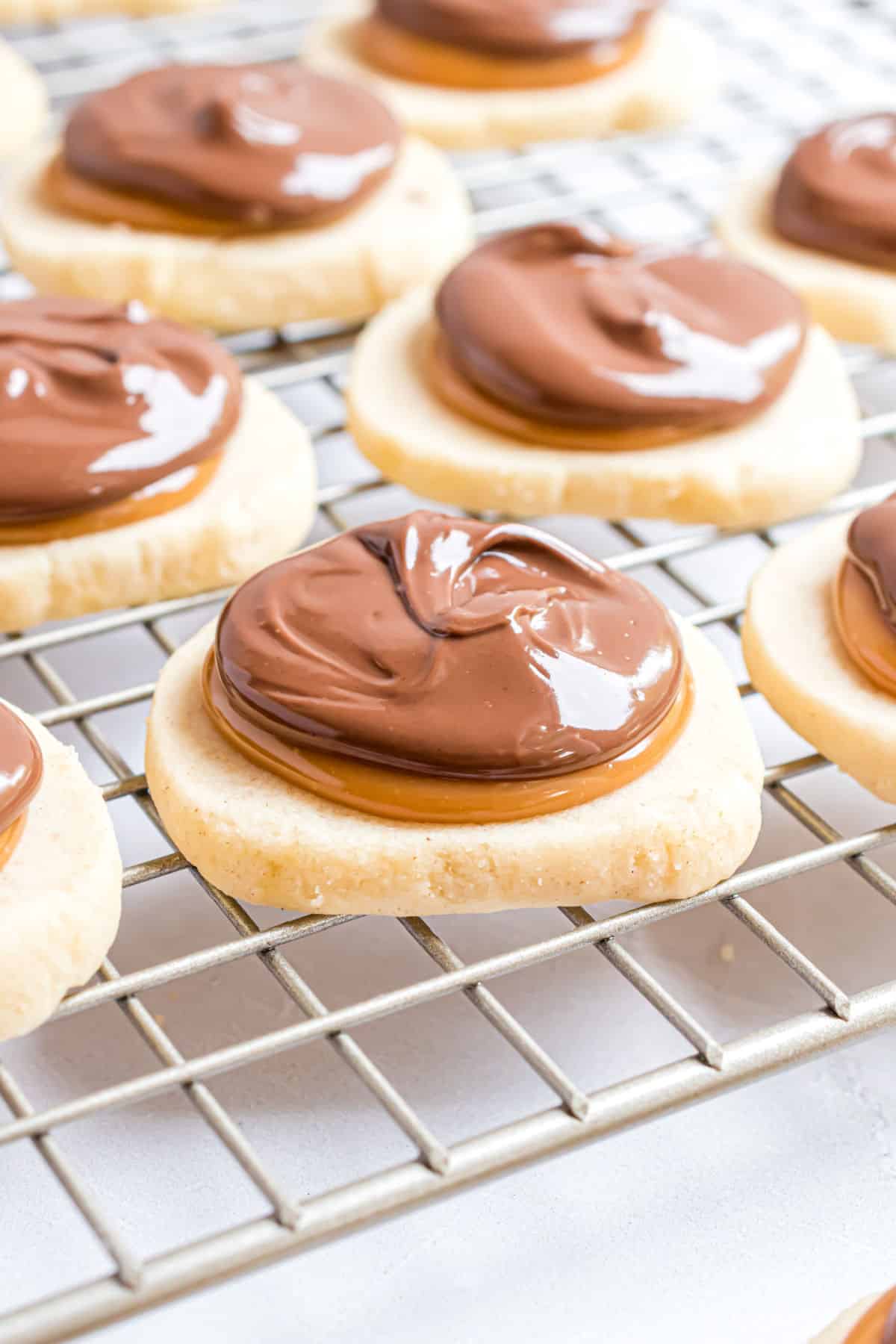 Twix cookies on a wire cooling rack.