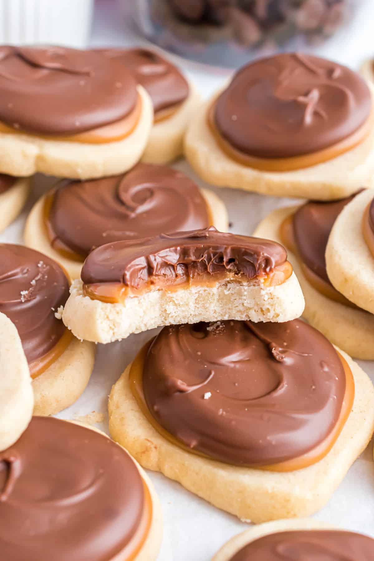 Twix cookies stacked with one having a bite taken out.