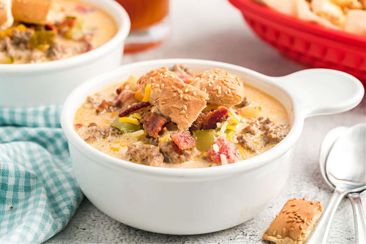 Bacon cheeseburger soup in a white bowl.