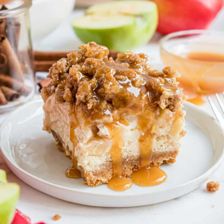 One bite of these Caramel Apple Cheesecake Bars and you'll be smitten! Cookie crust with creamy cheesecake filling, fresh apples, and a thick brown sugar streusel are topped with a drizzle of decadent caramel sauce!