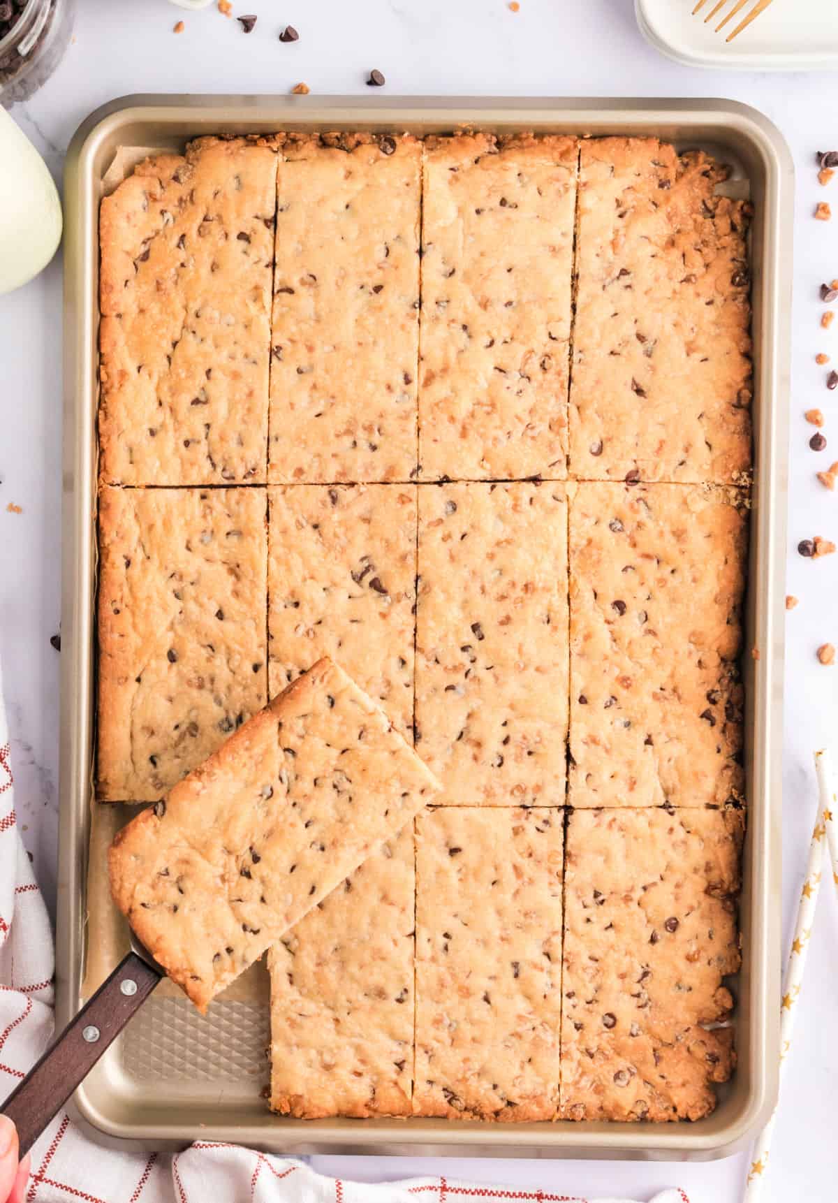 Chocolate chip shortbread cookies with toffee in a baking sheet.