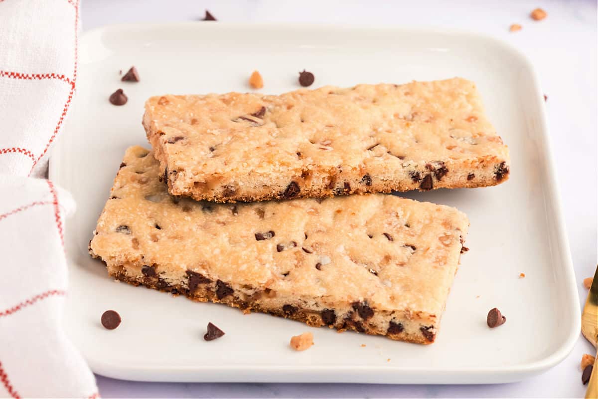 Two shortbread cookie bars on a white plate.