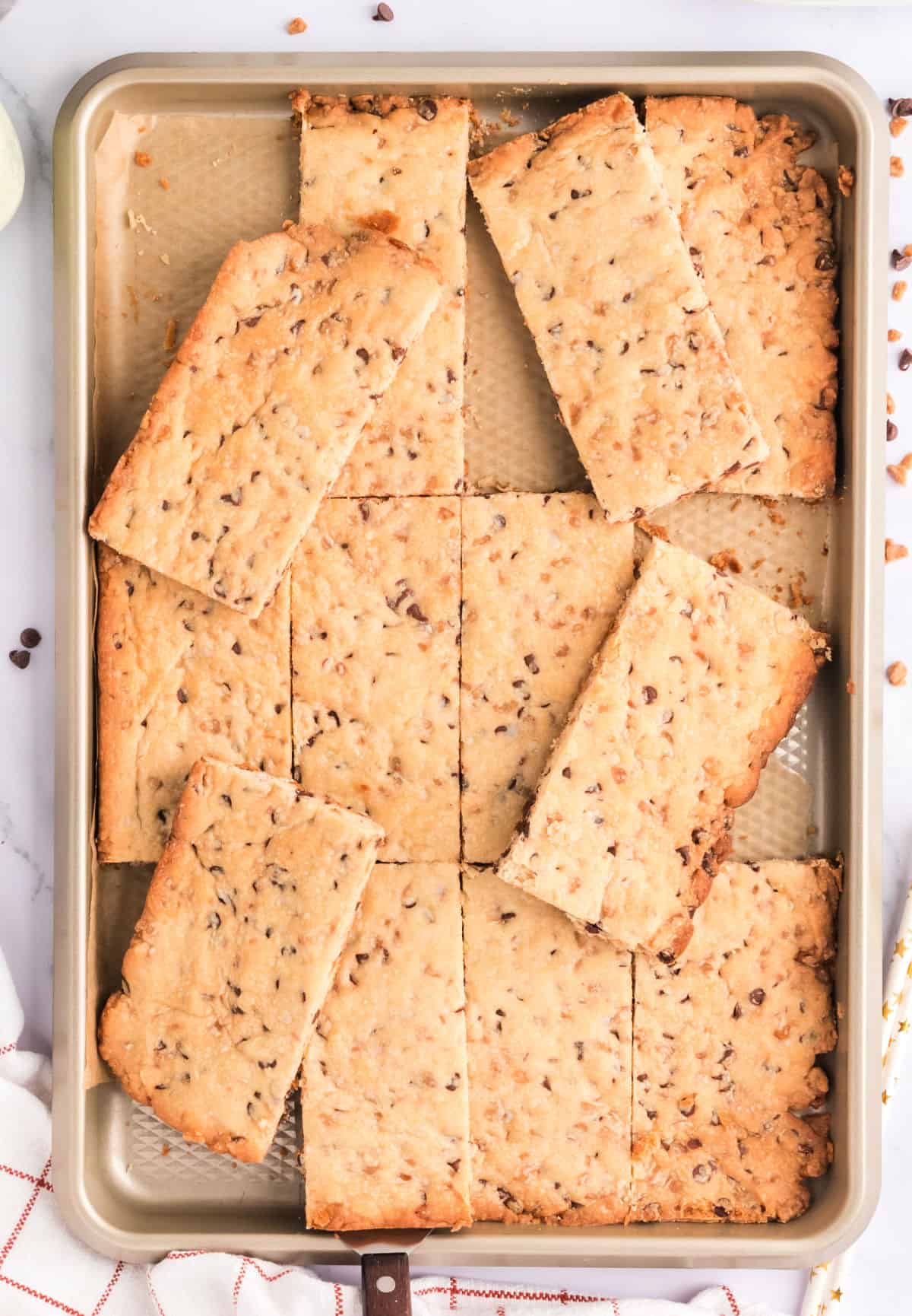 Baking sheet stacked with shortbread cookie bars.