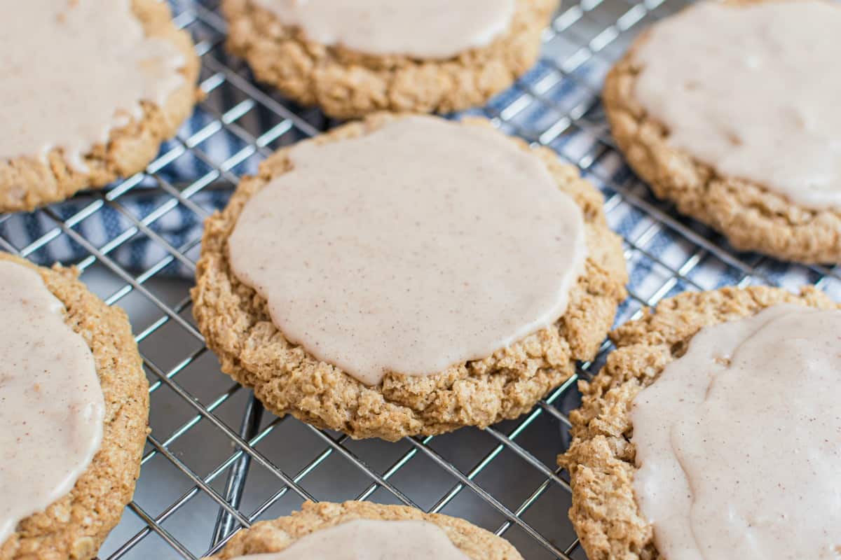 Cinnamon glazed oatmeal cookies on a wire rack to cool.